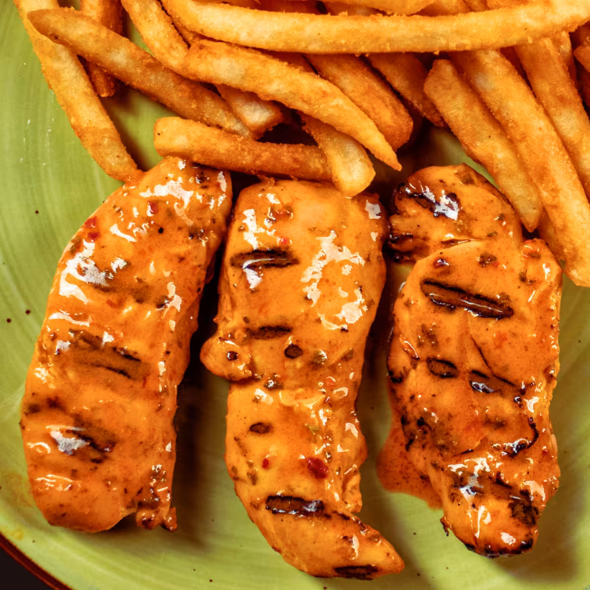 Peri peri chicken tenders served with seasoned rice and fresh salad at La Peri Peri Sterling Heights
