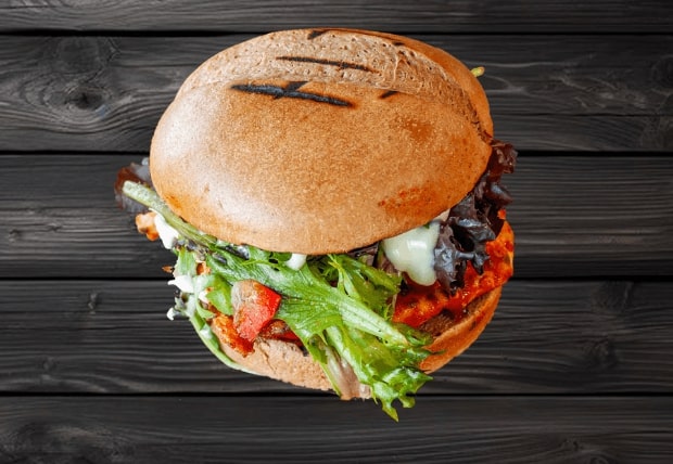 Zabiha Halal peri chicken burger with lettuce, tomato, cheese, and pickles served at La Peri Peri in Sterling Heights, MI