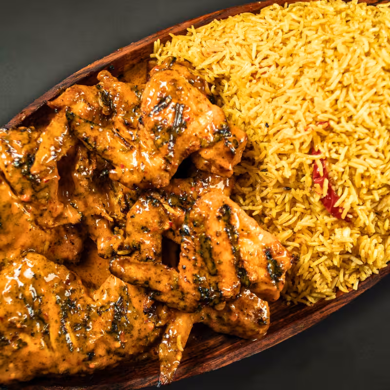 Zabiha Halal mixed platter with ½ grilled chicken, 5 wings, rice, and vegetables at La Peri Peri in Sterling Heights, MI