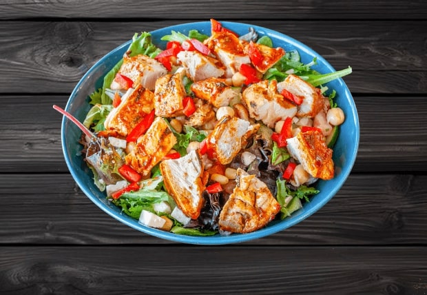 Peri spring bowl with Zabiha Halal grilled chicken, spring mix, chickpeas, feta, tomato, and cucumber at La Peri Peri in Sterling Heights