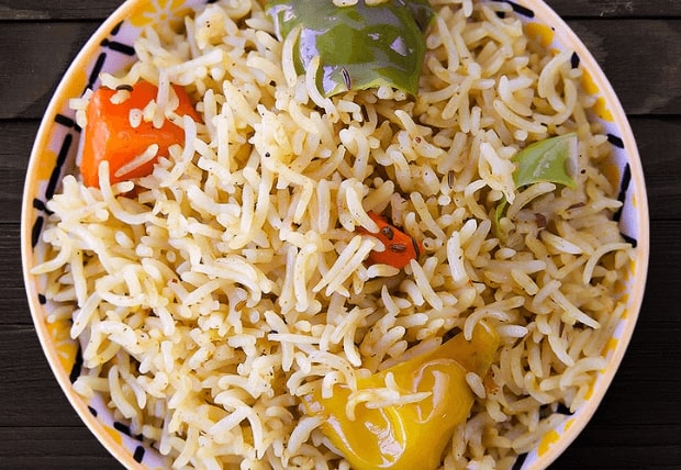 Bowl of fluffy house-made rice with colorful peppers served at La Peri Peri in Sterling Heights, MI