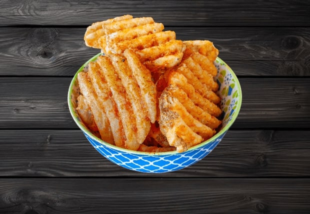 Crisscross-cut waffle fries served in a patterned bowl at La Peri Peri Sterling Heights