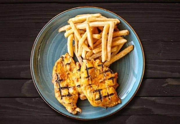 Zabiha Halal peri peri grilled chicken fillets with fries on a blue plate at La Peri Peri, Sterling Heights, Michigan