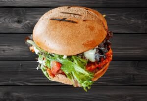 Zabiha Halal peri chicken burger with lettuce, tomato, cheese, and pickles served at La Peri Peri in Sterling Heights, MI