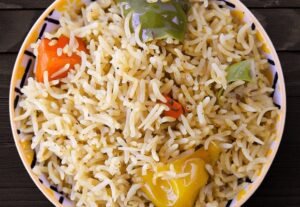 Bowl of fluffy house-made rice with colorful peppers served at La Peri Peri in Sterling Heights, MI