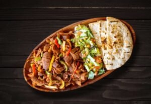 Signature Doner with Zabiha Halal beef, sautéed onions and peppers, served with naan at La Peri Peri in Sterling Heights