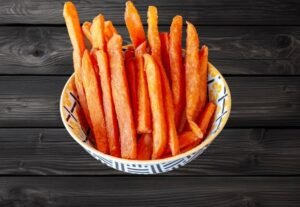 Crispy sweet potato fries served in a patterned bowl at La Peri Peri Sterling Heights
