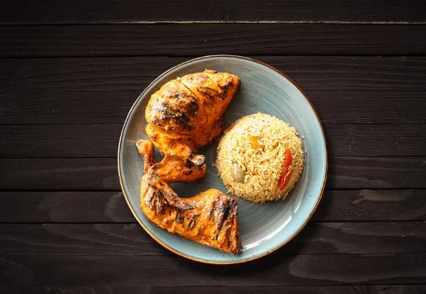 Grilled 1/2 chicken with breast, wing, and leg served with seasoned rice.