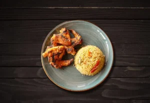 Zabiha Halal grilled chicken wings served with seasoned rice at La Peri Peri Sterling Heights