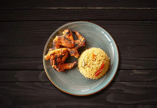 Four grilled chicken wings served with seasoned rice